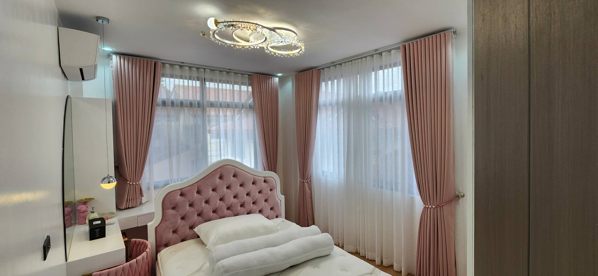Bedroom with blush pink S-fold blackout curtains and white sheer curtains