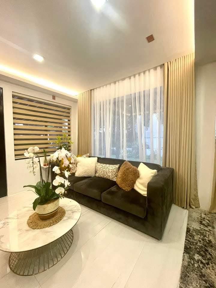 Cozy living room with beige floor-length curtains, white sheers, and Korean combi blinds