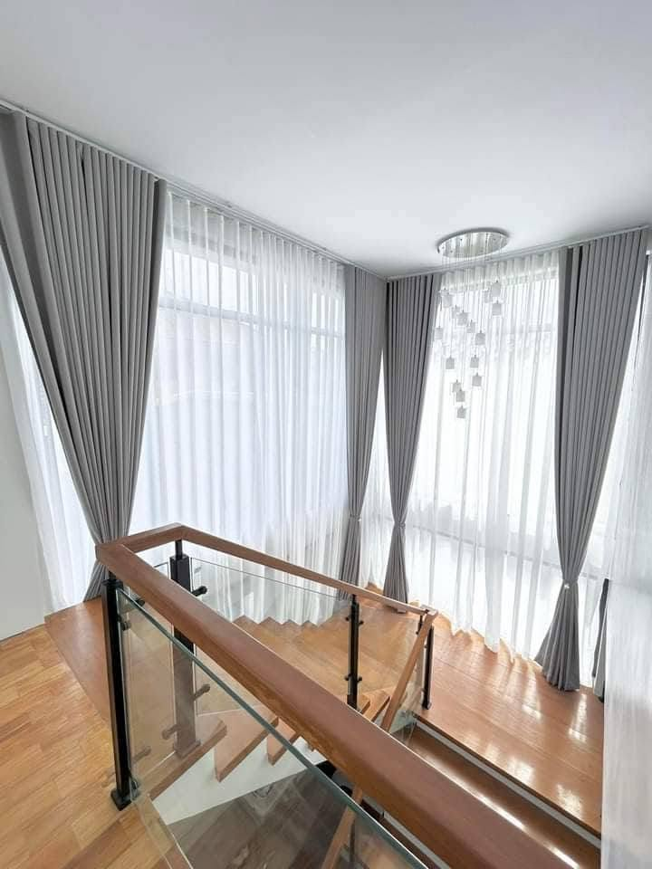 S-fold curtains against high ceiling window