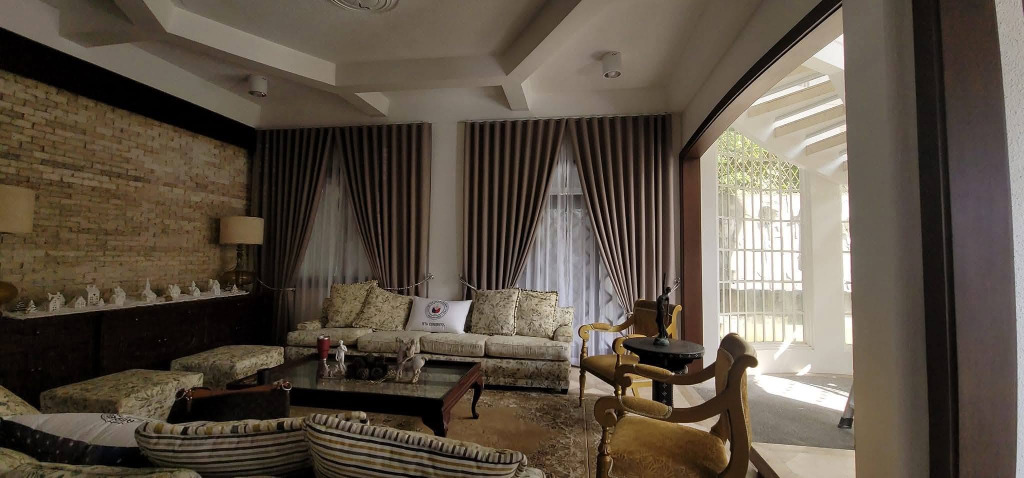 Custom layered curtains and sheers installed in a classic residential living room