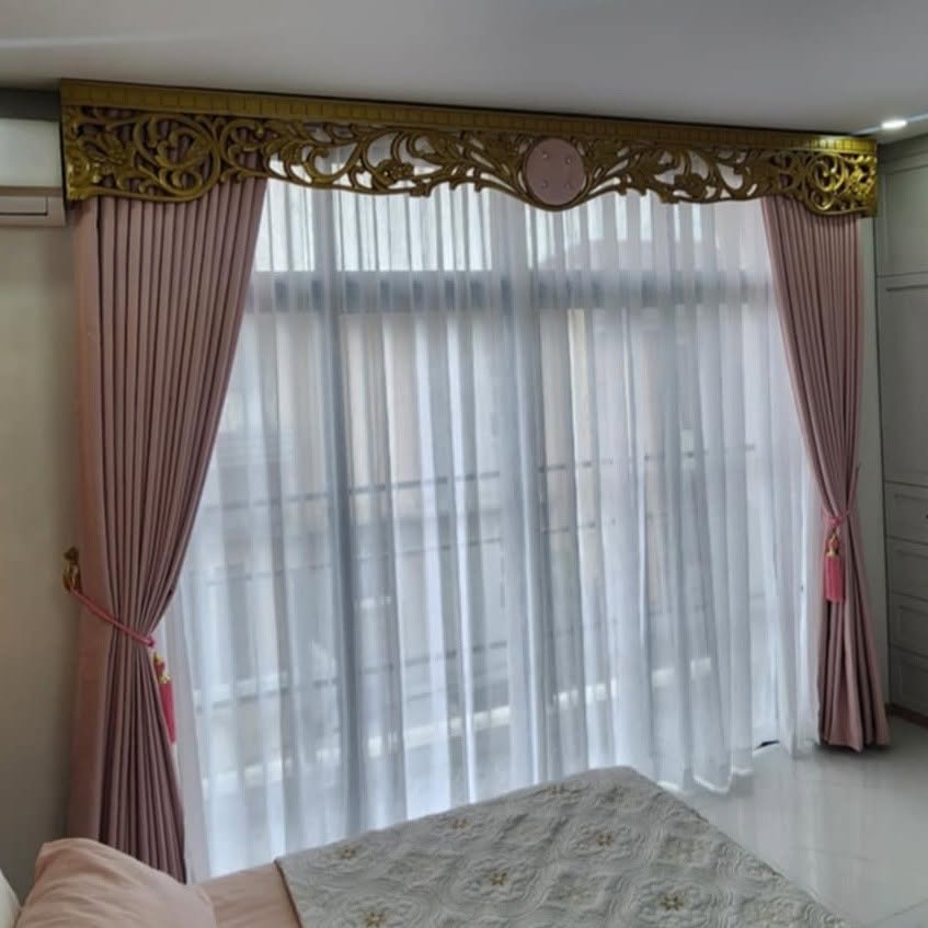 Bedroom window with soft pink velvet drapes, white sheer curtains and ornate gold carved pelmet