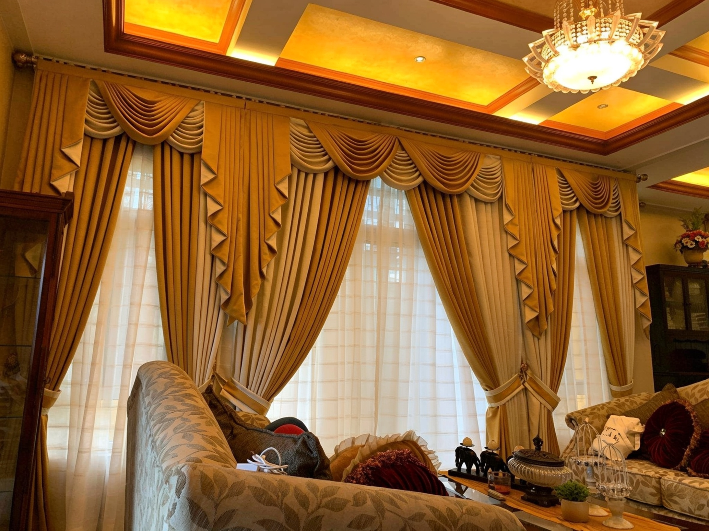 Swag curtains draped over a formal window
